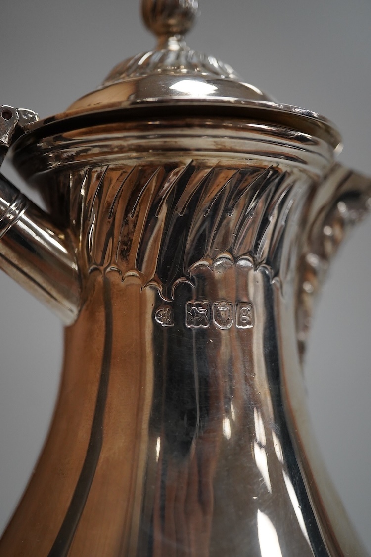 An Edwardian demi-fluted silver baluster hot water jug, William Hutton & Sons, London, 1902, height 21cm, 13.4oz.